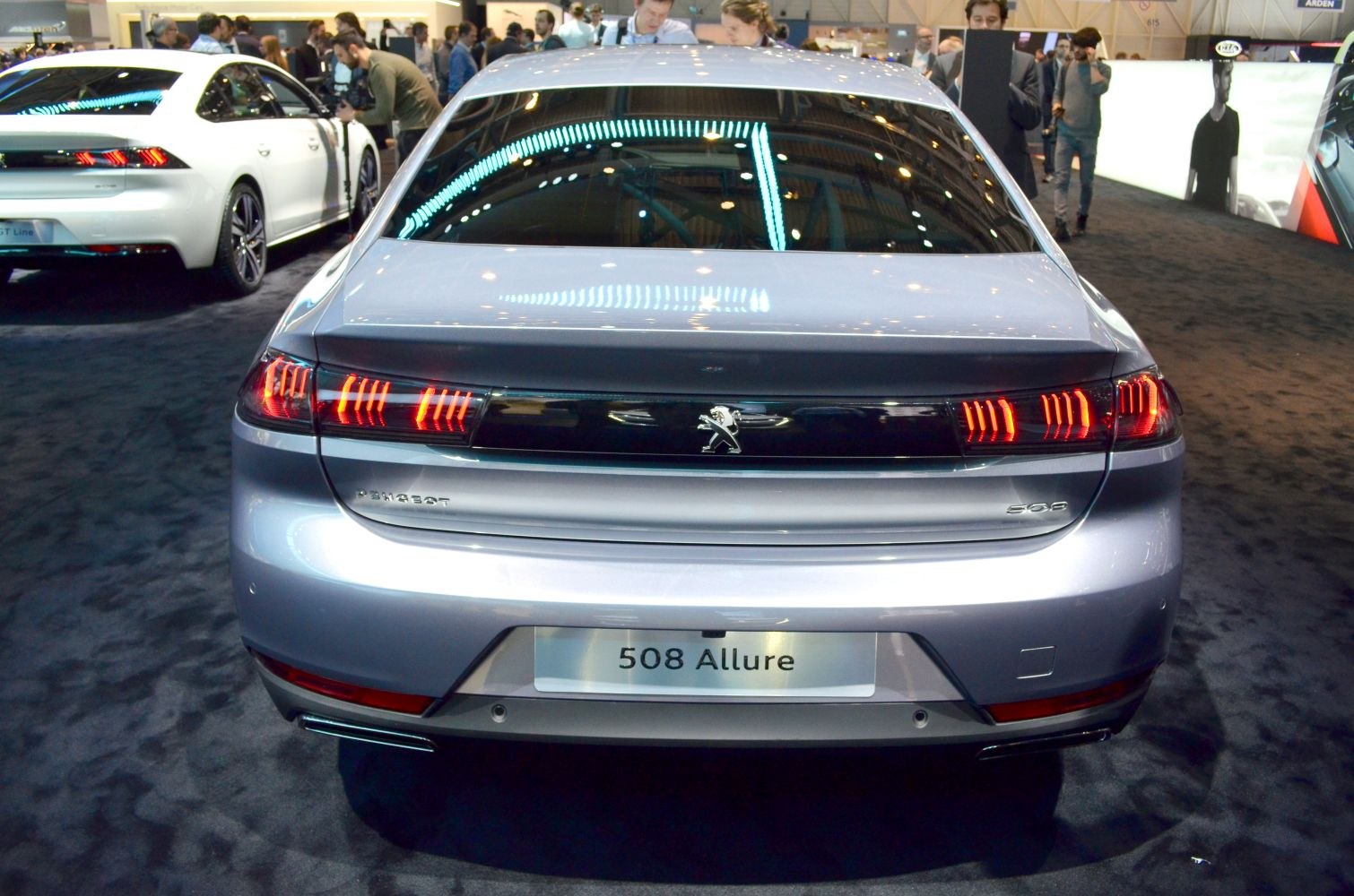 Rear view of sleek sedan with distinctive three-claw LED tail lights