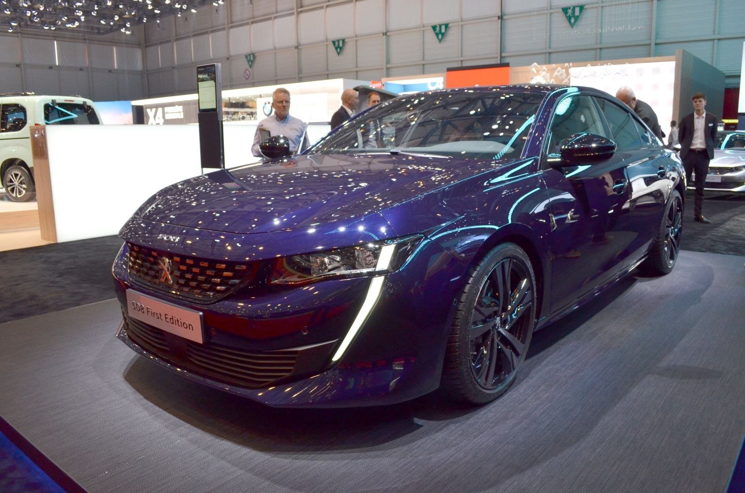 Modern sedan front with LED daytime running lights and sporty wheels
