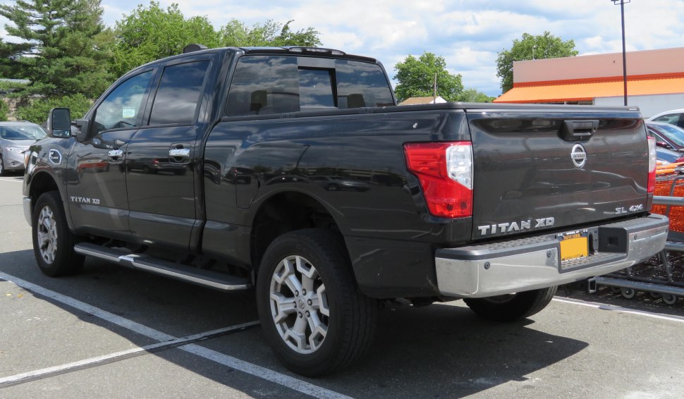 Black crew cab pickup rear and side view with cargo bed