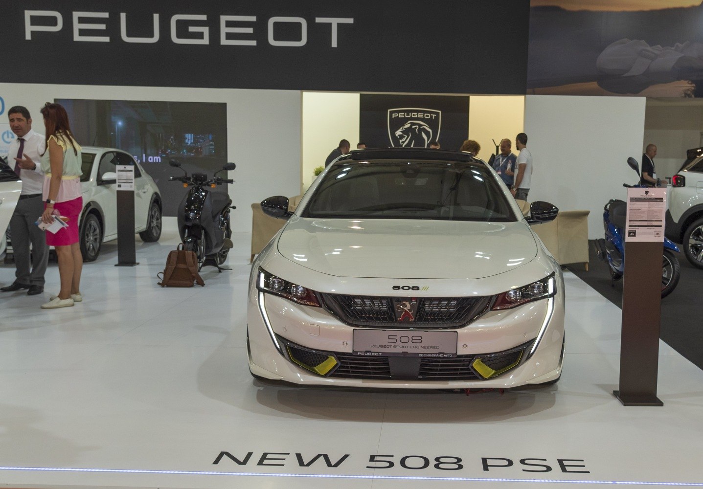 White sporty sedan front with LED headlights and wide grille
