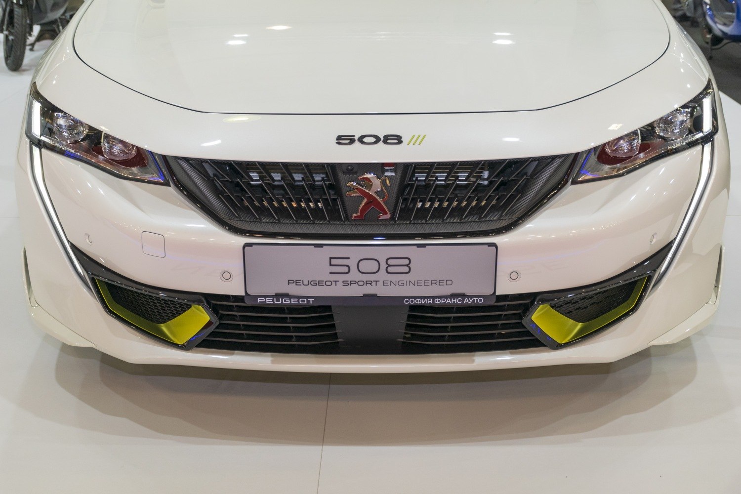 Front grille with emblem and LED headlights with yellow accents