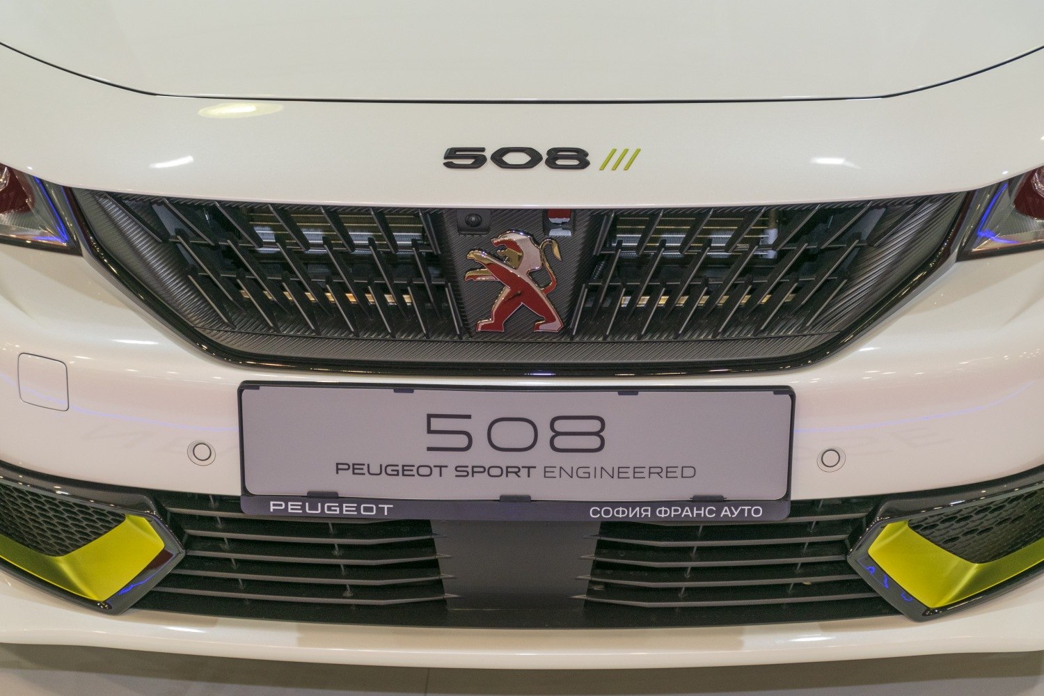 Front grille with Peugeot lion badge and sporty design elements.