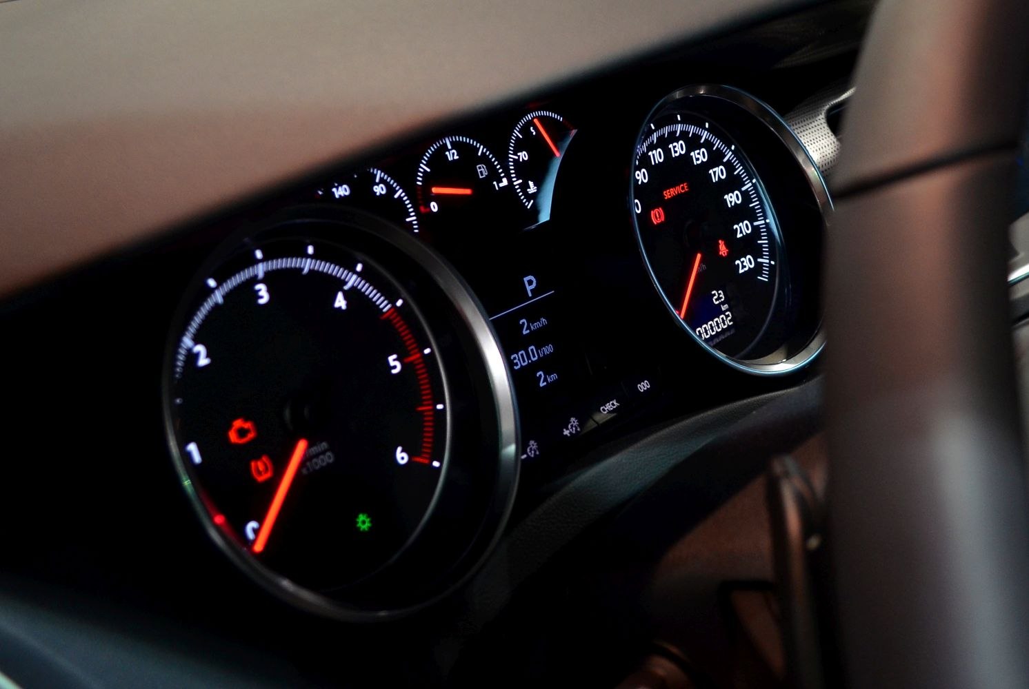 Instrument cluster with speedometer, tachometer, fuel gauge, and warning indicators