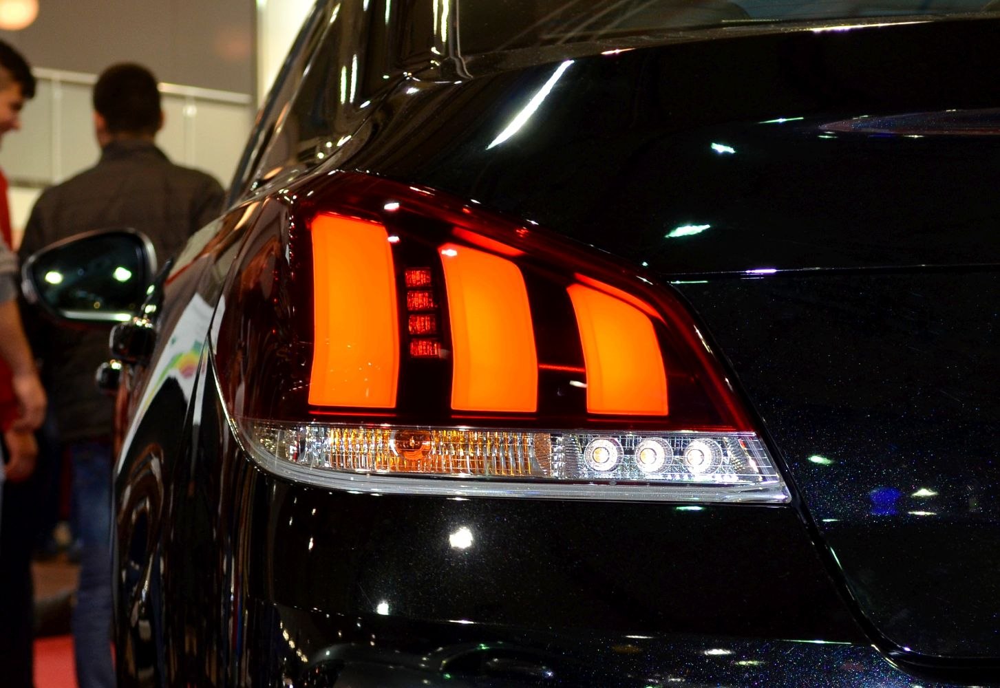 Close-up of rear tail lights with distinctive triple vertical stripe design
