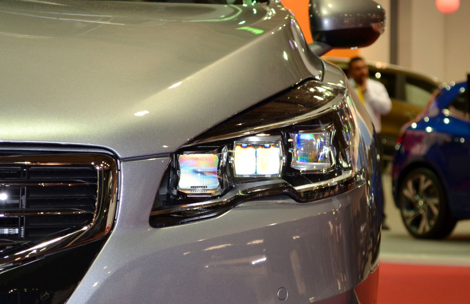 Close-up of modern LED headlight and front grille