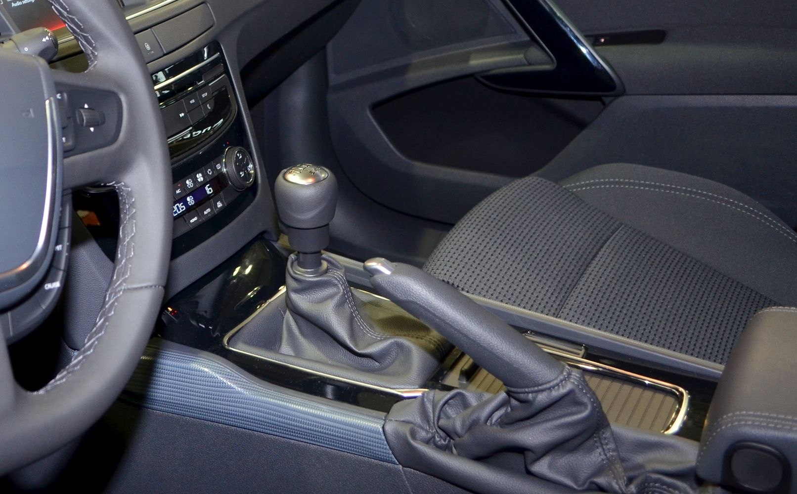 Manual gear shift lever and handbrake close-up in car interior