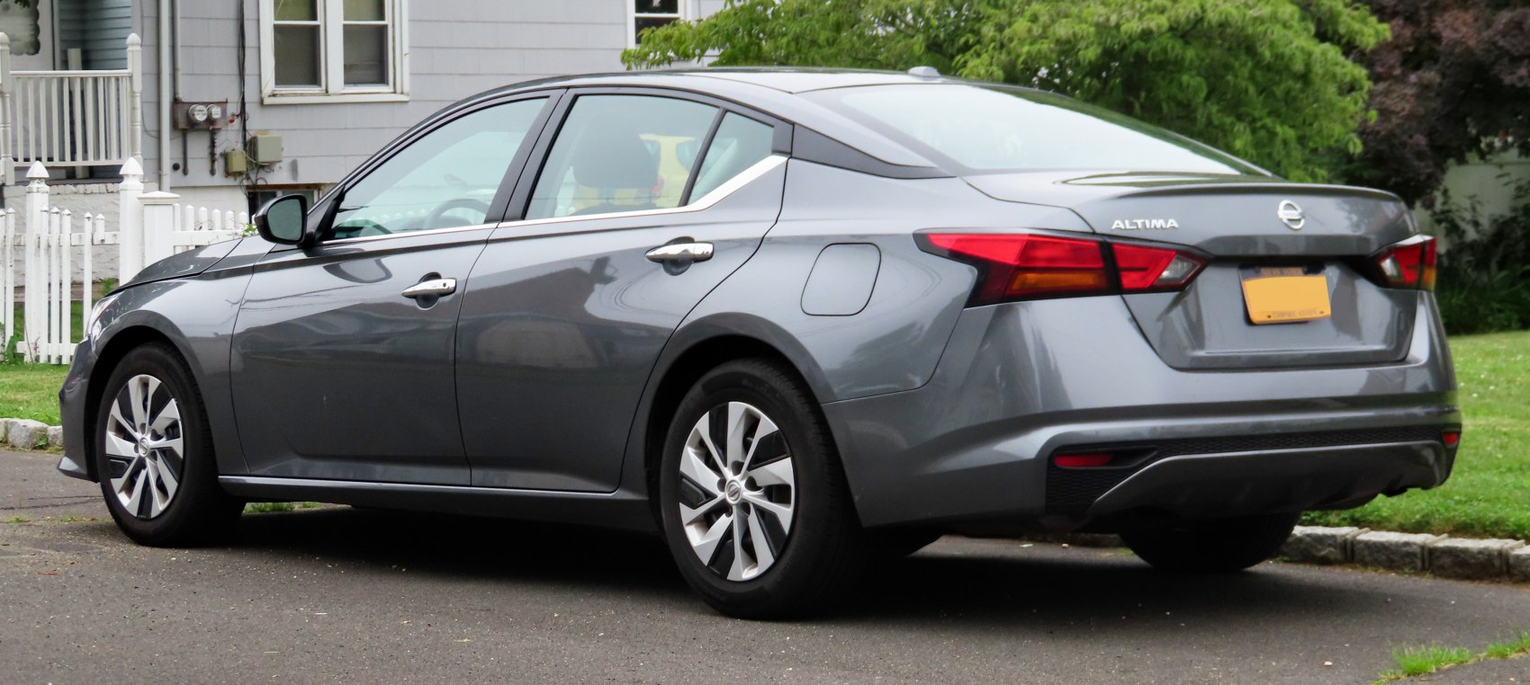 Rear side of sedan with modern tail lights and alloy wheels