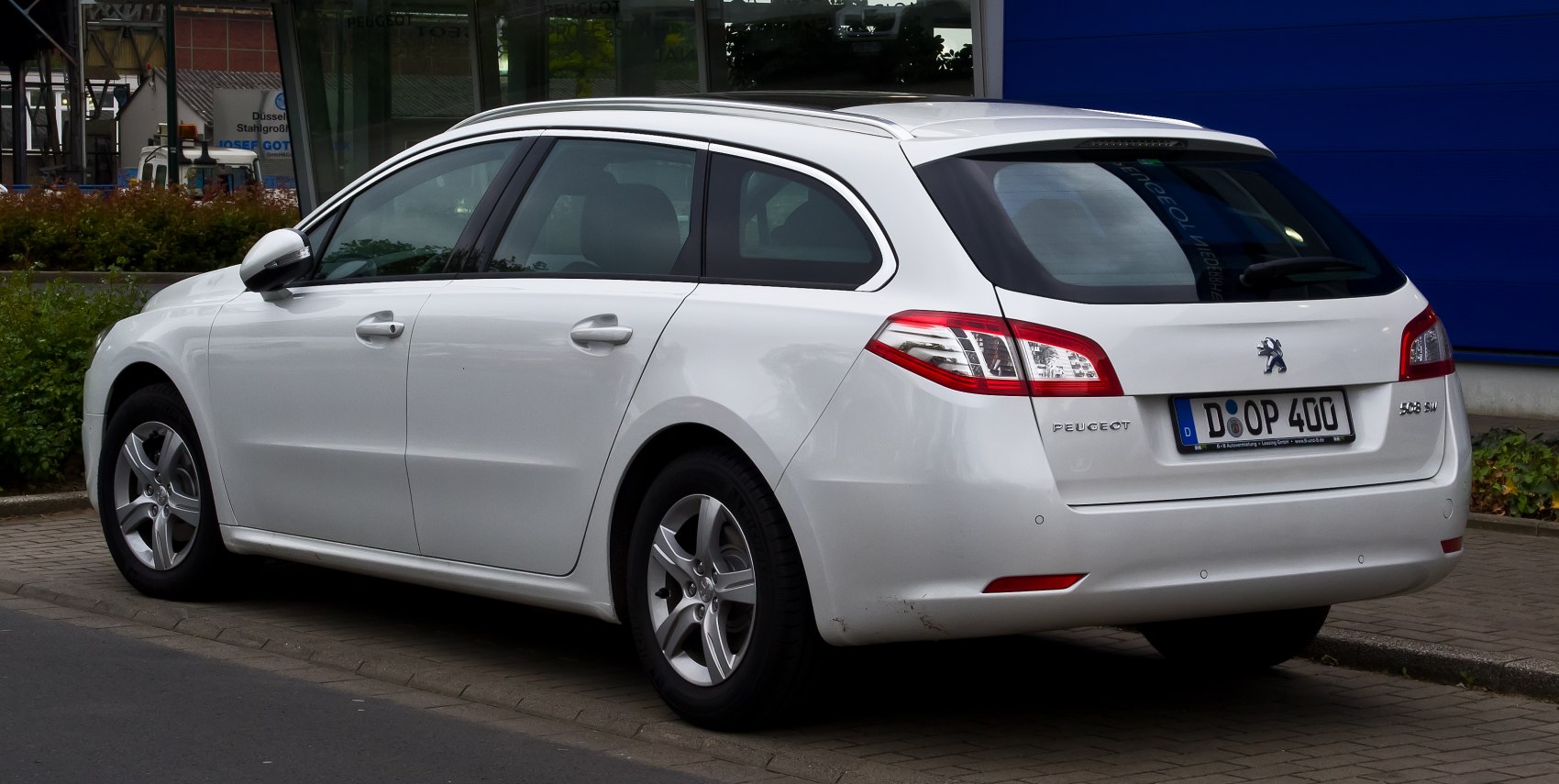 Rear side view of a station wagon with distinct tail lights and five doors