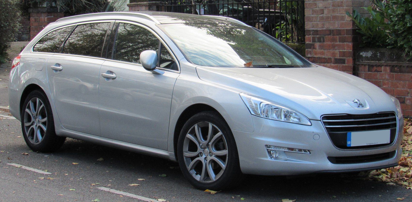 Silver 5-door station wagon front side with headlights and alloy wheels