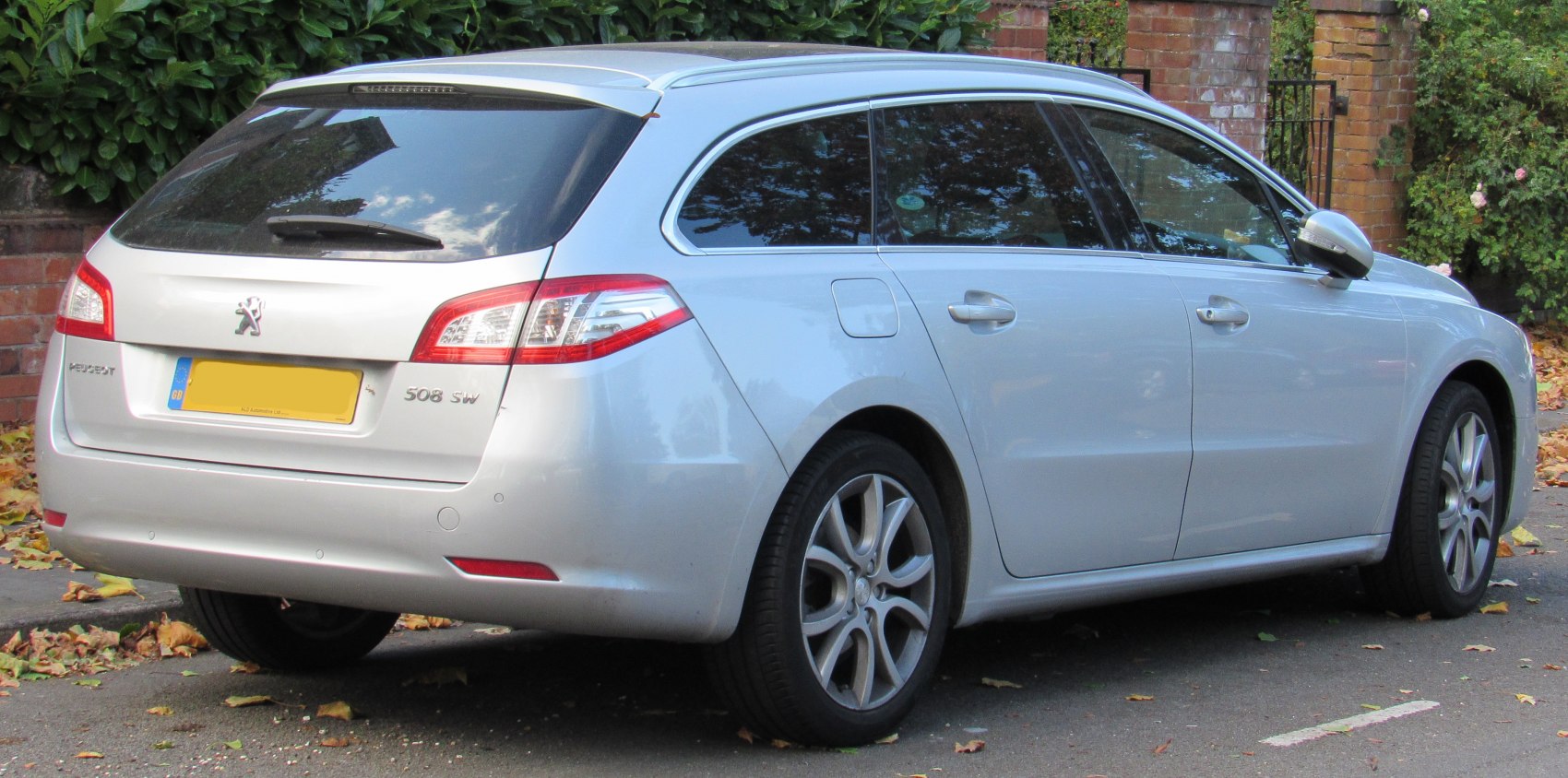 Rear and side view of a silver estate car with distinct tail lights and alloy wheels.