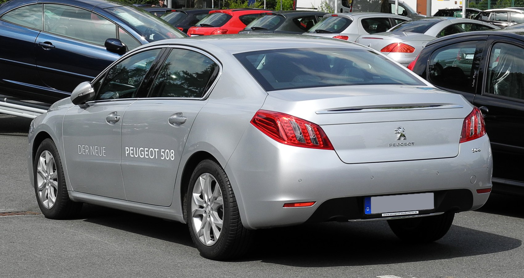 Rear side view with sleek body and distinctive triple-segment tail lights
