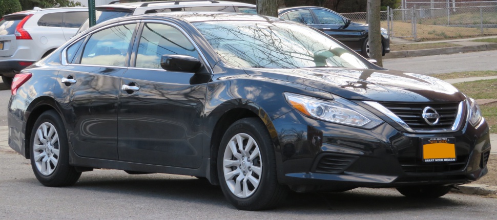 Front side view showing headlights, grille, and wheels of a sedan