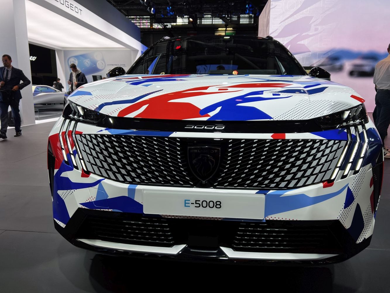 Front view with striking grille and LED headlights in red-white-blue camouflage wrap