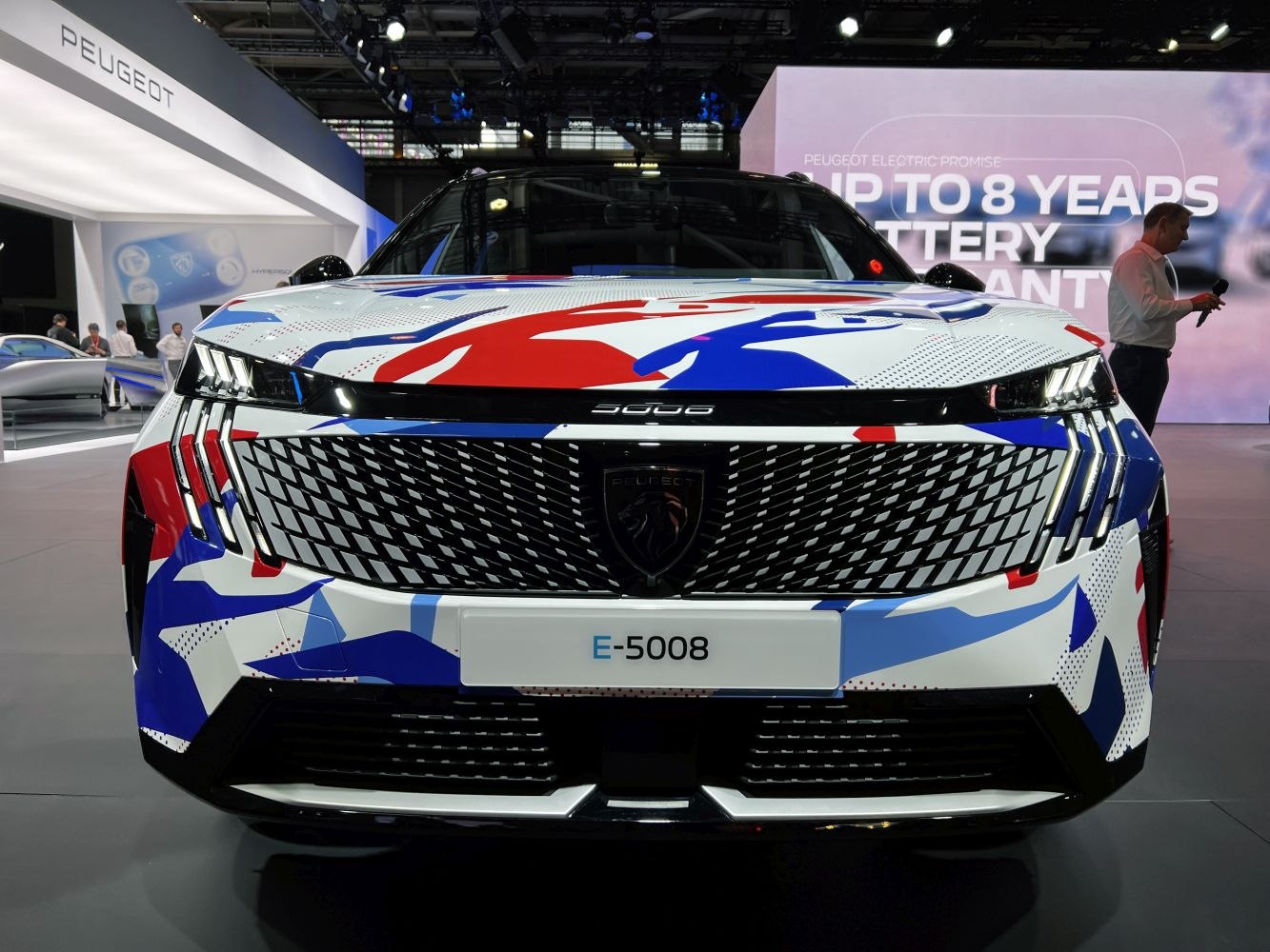 Futuristic front grille with triple-claw LED headlights on modern SUV