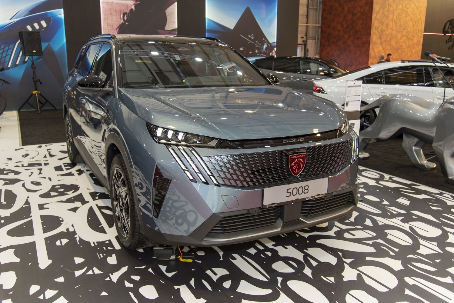 Front view of SUV with bold grille and triple-split LED headlights