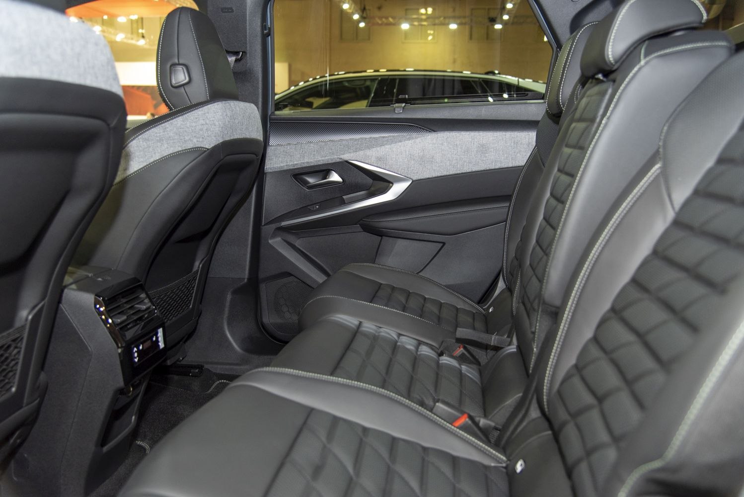 Luxurious rear leather seats and modern door panel design.