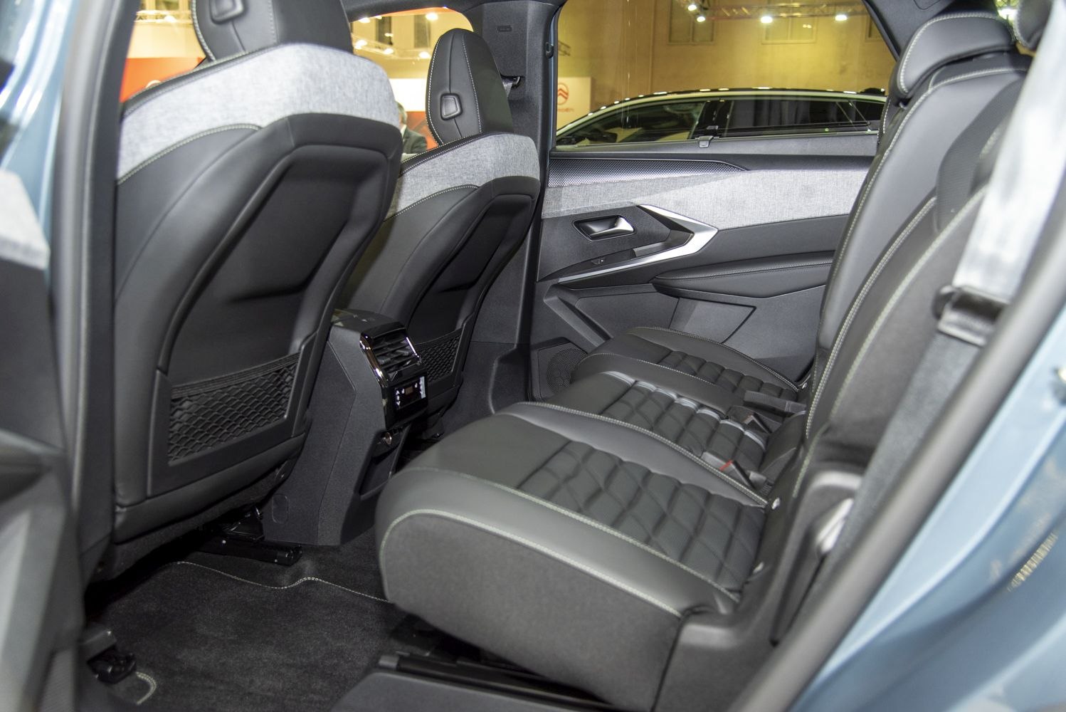 Stylish rear passenger seat interior with premium upholstery and spacious design.