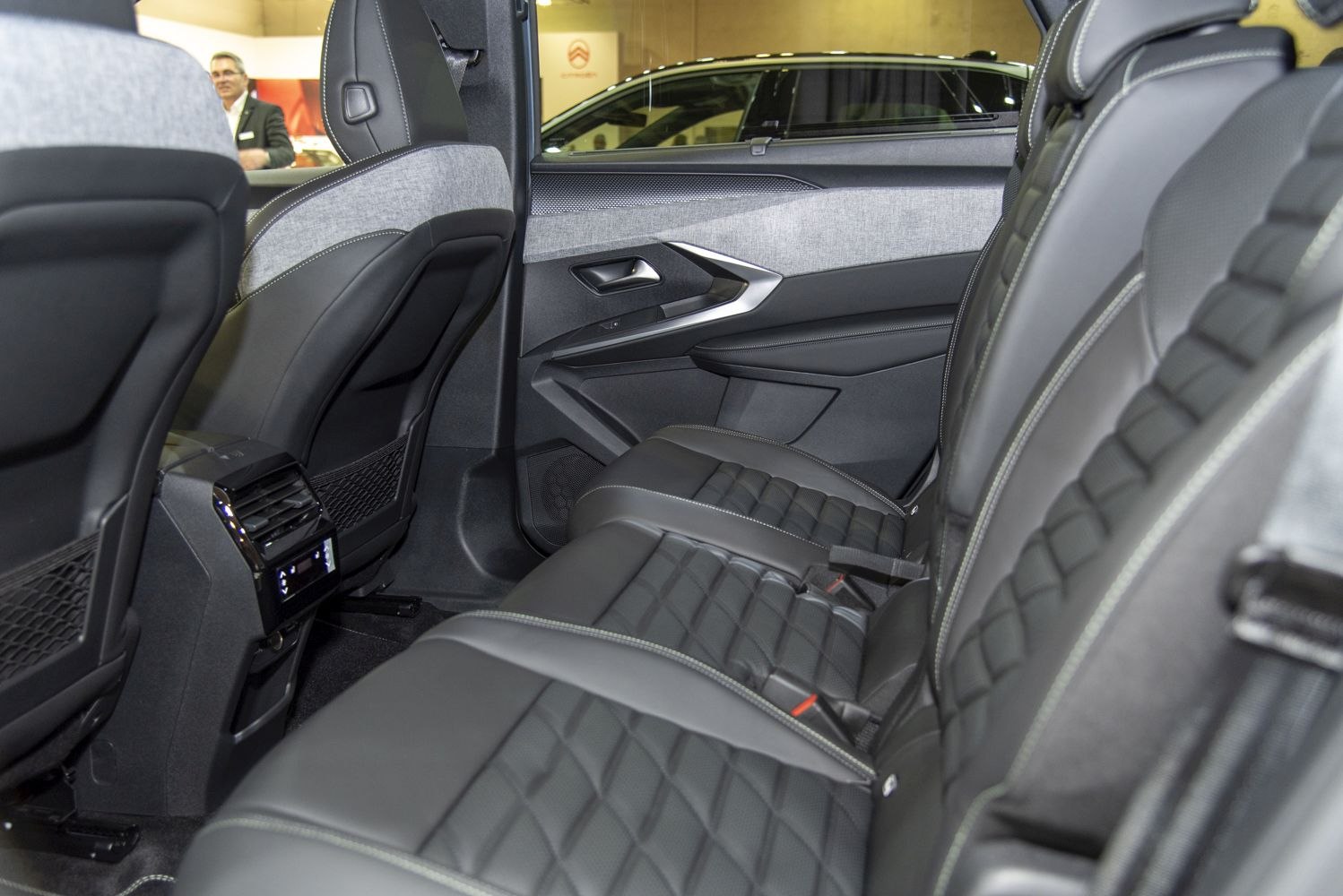Rear interior with premium leather seats and modern door panel.