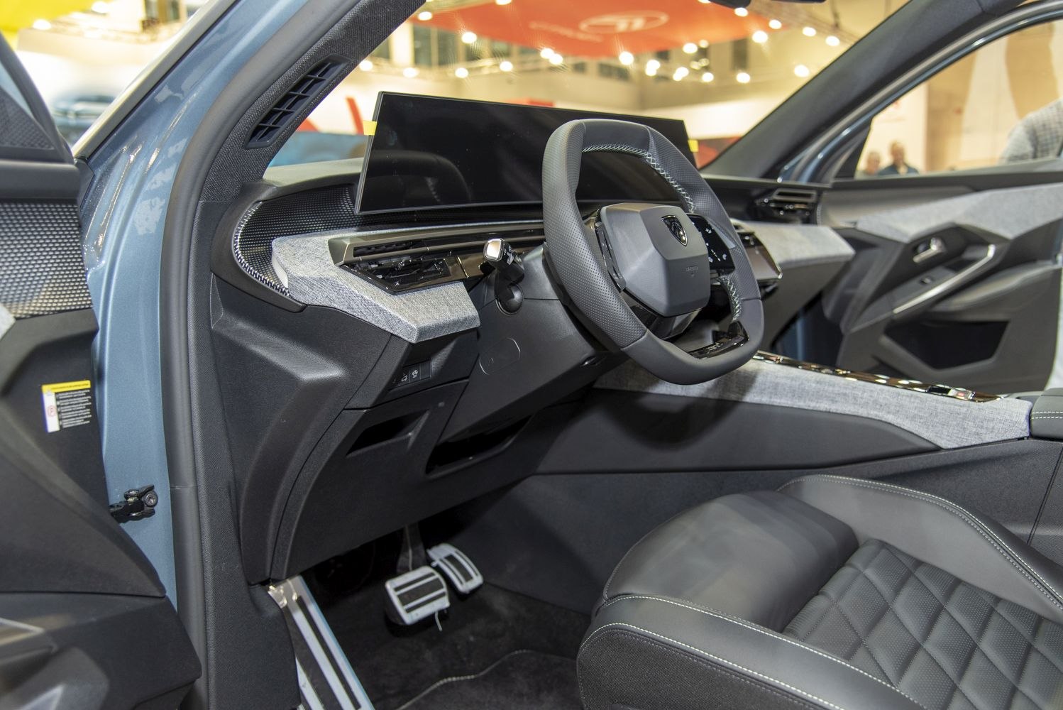 Modern car interior with digital dashboard and compact steering wheel