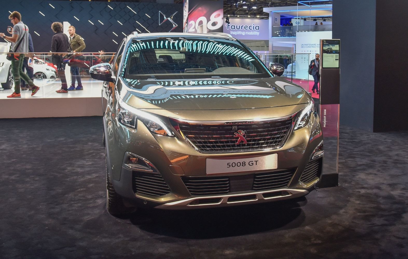 Bold grill with Peugeot emblem and sharp LED headlights from front view.