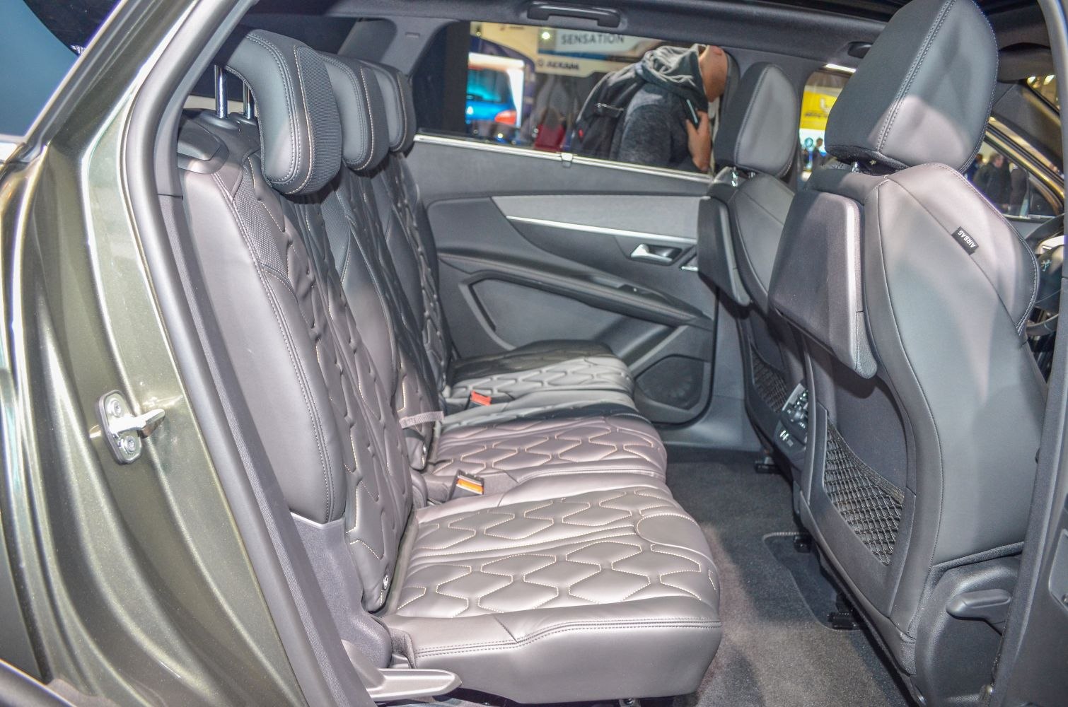 Rear leather seats with detailed stitching in spacious car interior