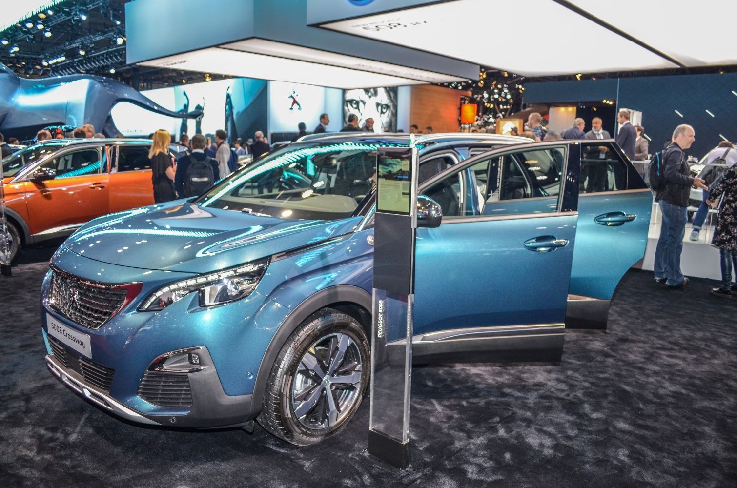 Blue compact SUV front and side view with open doors and alloy wheels
