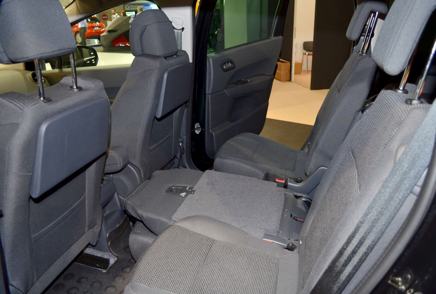Rear interior with foldable seats and door panel in black upholstery
