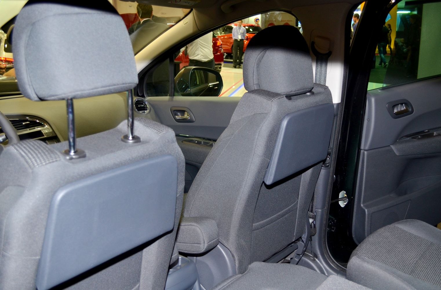 Rear seat tray tables with dark fabric upholstery and car door panel