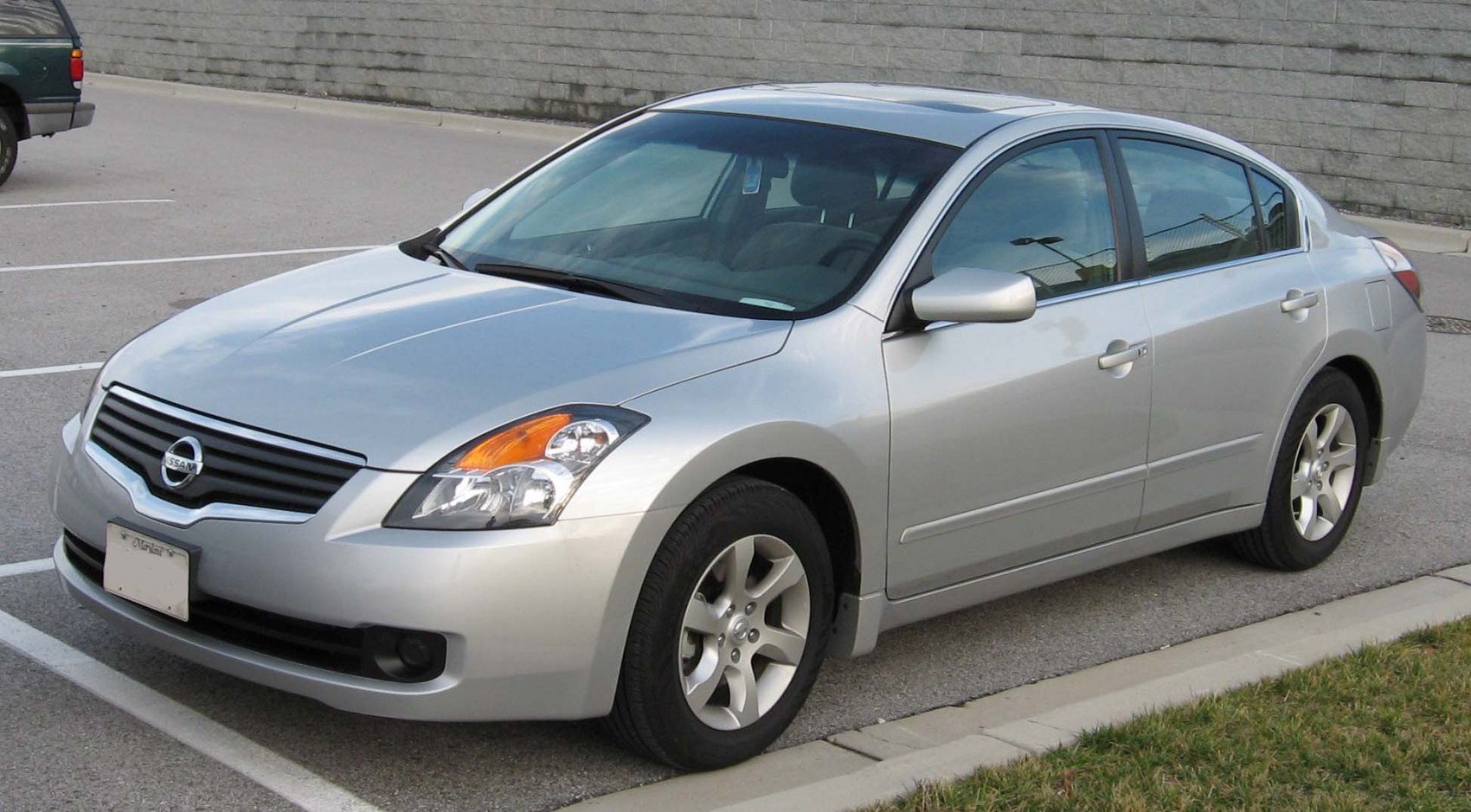 Silver sedan front and side view with headlights and grille