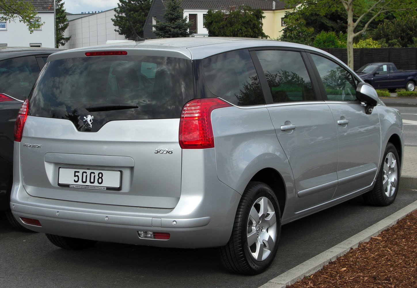 Rear view of a compact crossover with distinctive rear lights and tinted windows.