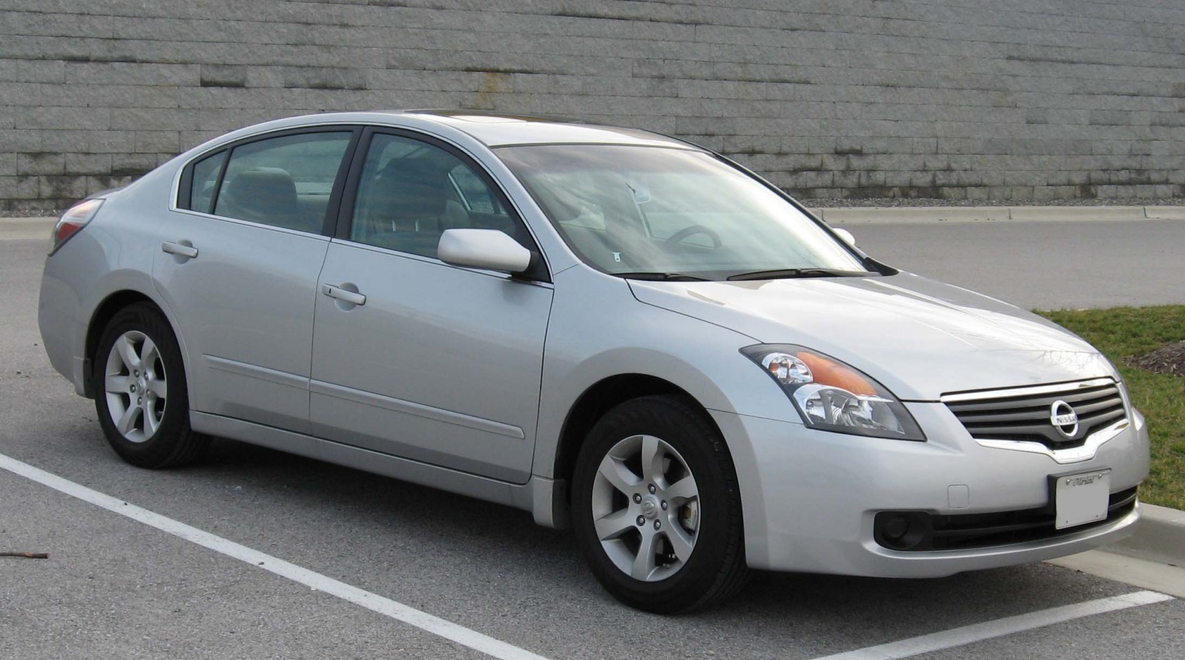 Silver sedan with distinctive headlights and alloy wheels.