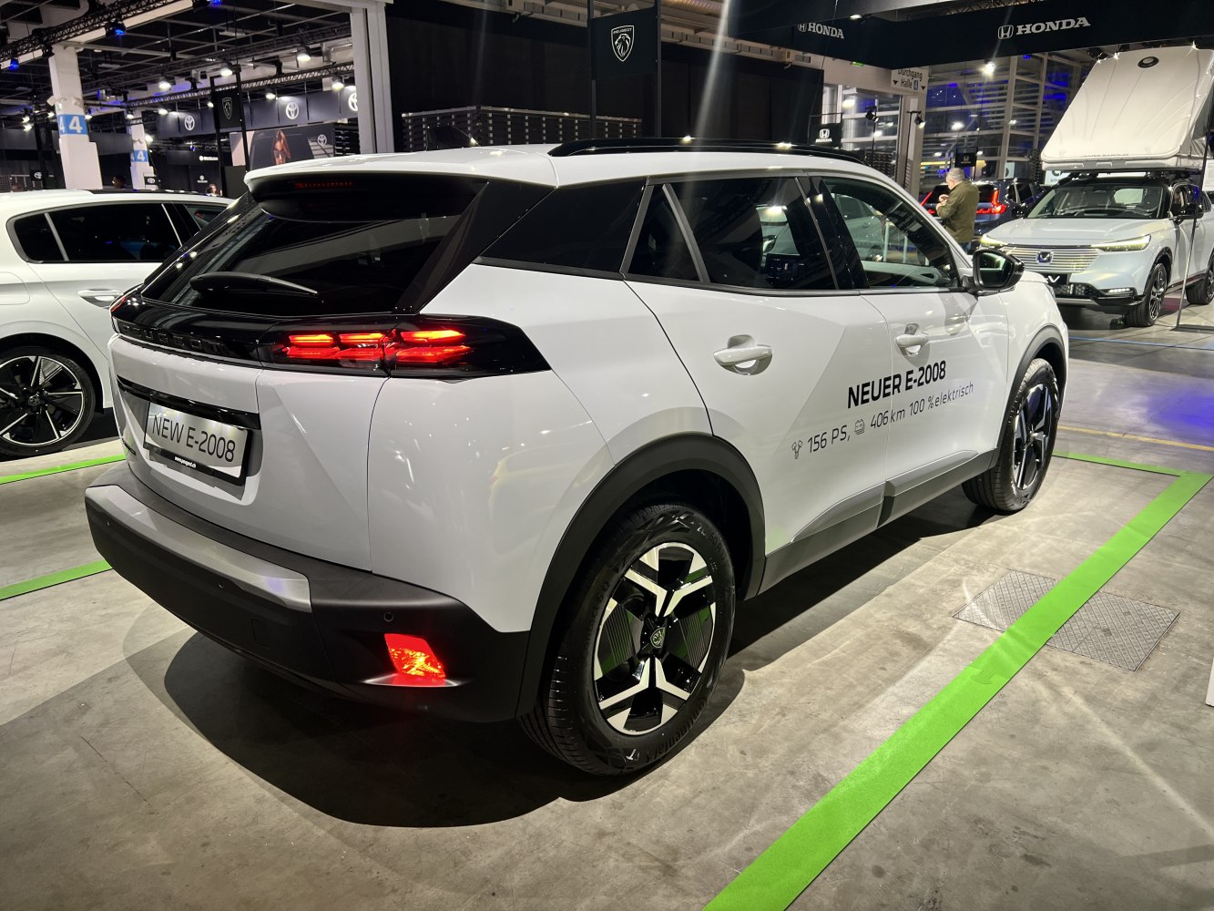 Rear view of an electric SUV with taillights and alloy wheels.