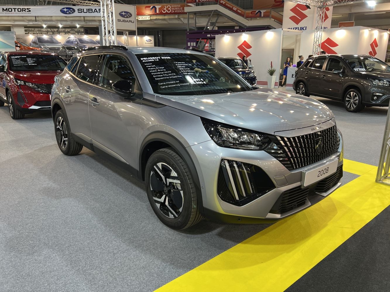 Front grille and LED headlights of a modern SUV at an auto show