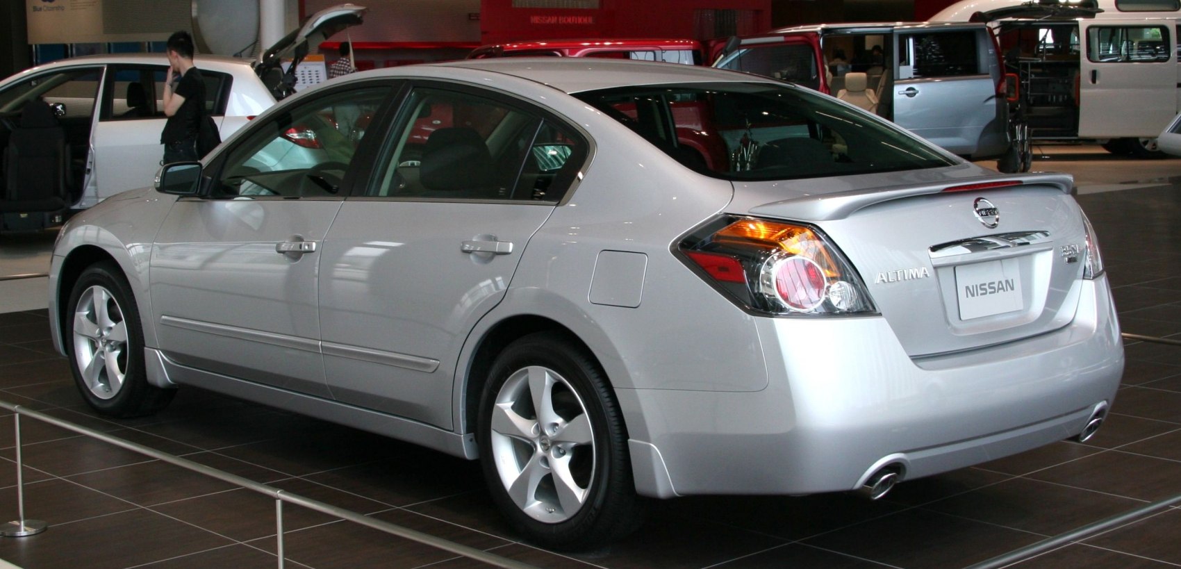 Rear view of sedan with spoiler and alloy wheels