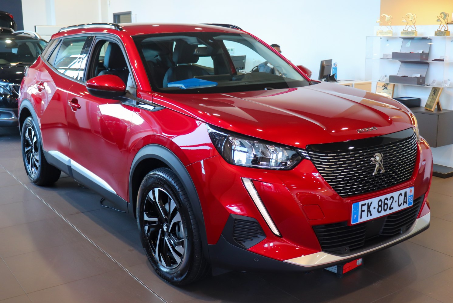 Red SUV with distinctive front grille and LED headlights