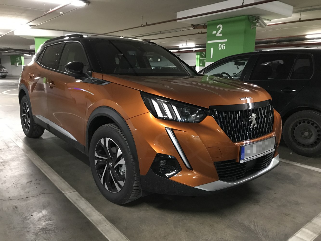 Front-side view of modern SUV with LED headlights and bold grille