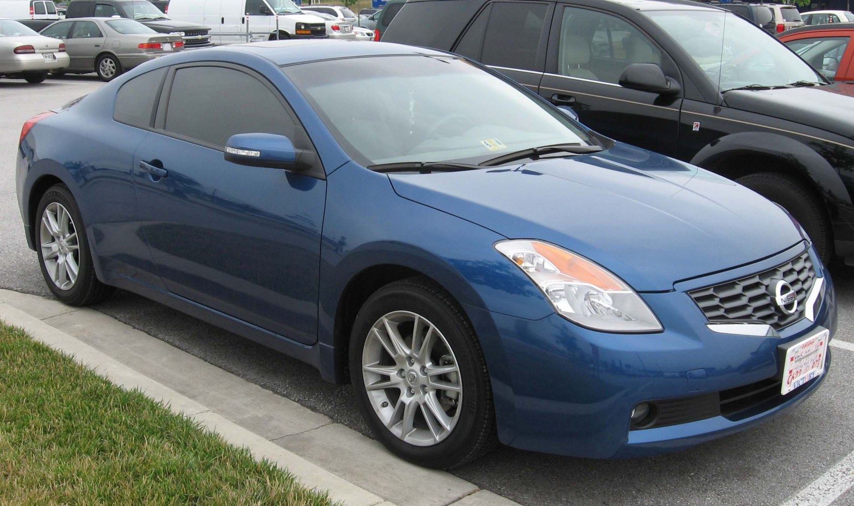Blue two-door coupe with alloy wheels and aerodynamic styling