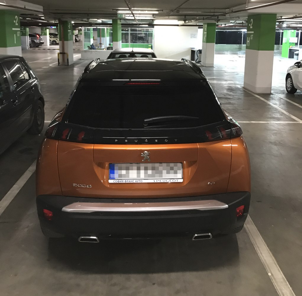 Rear view with tinted window, dual exhaust, and distinctive taillights