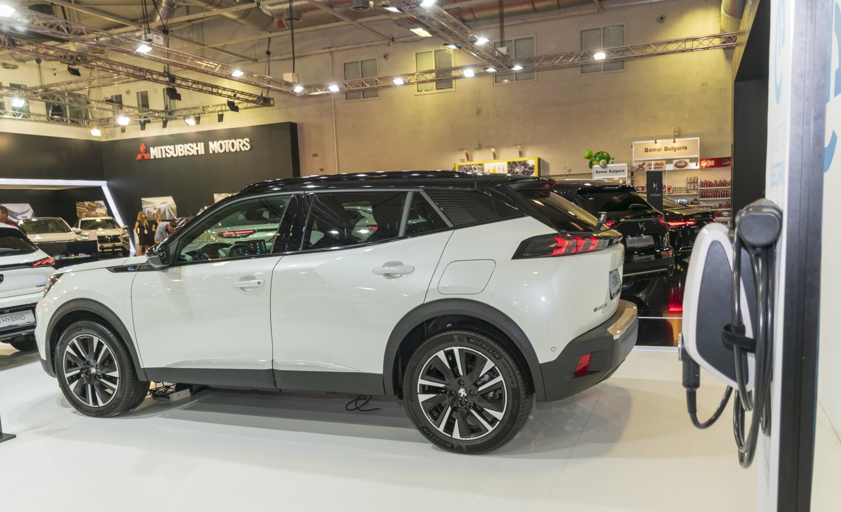 Side and rear view of compact electric SUV with modern wheels and charging port