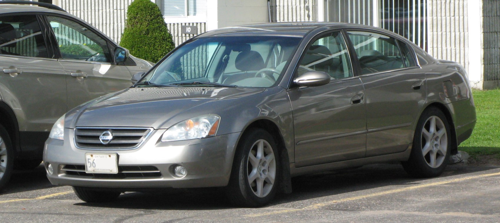 Side-front view of a sedan with alloy wheels and smooth body lines