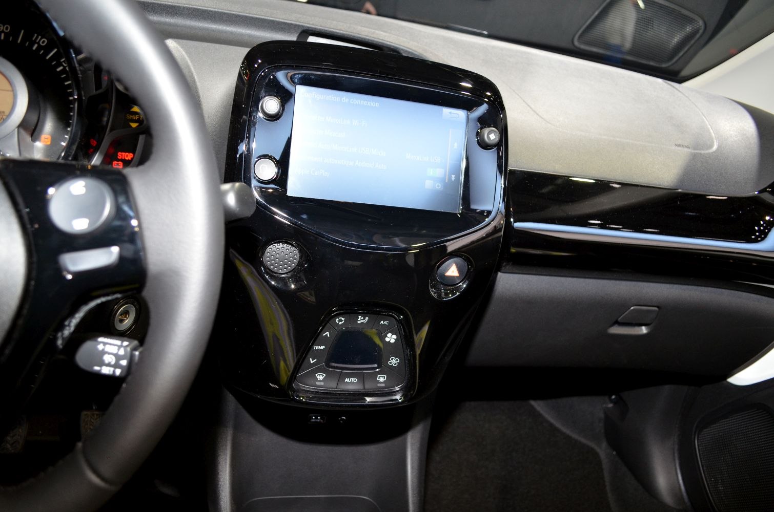Central touchscreen display and dashboard climate control panel in car interior