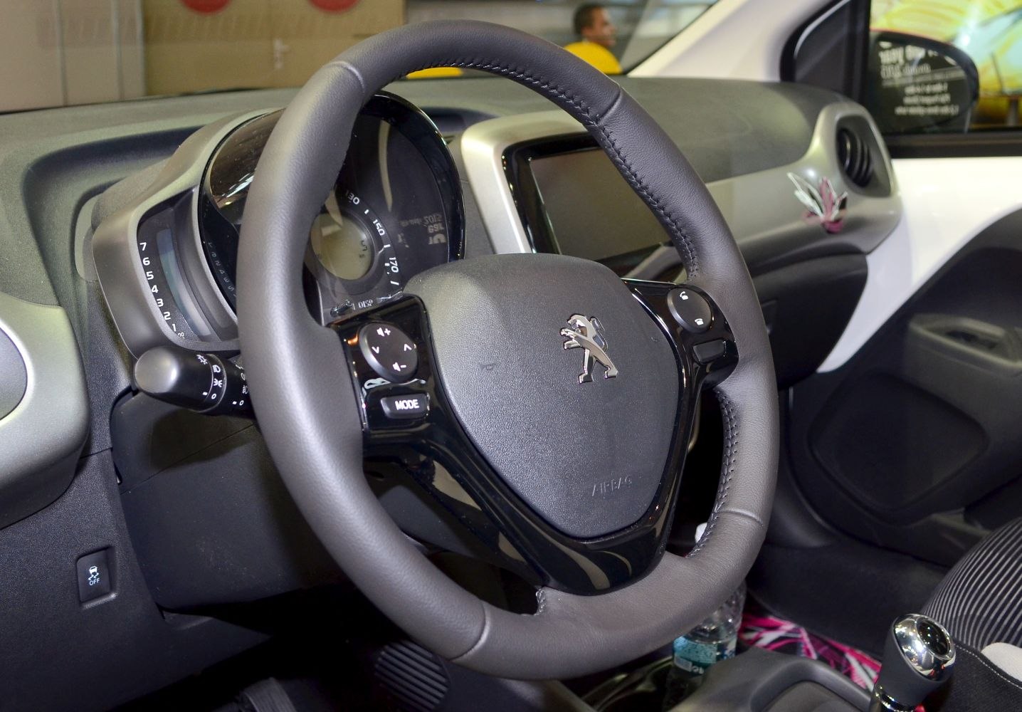 Steering wheel and dashboard with controls in car interior