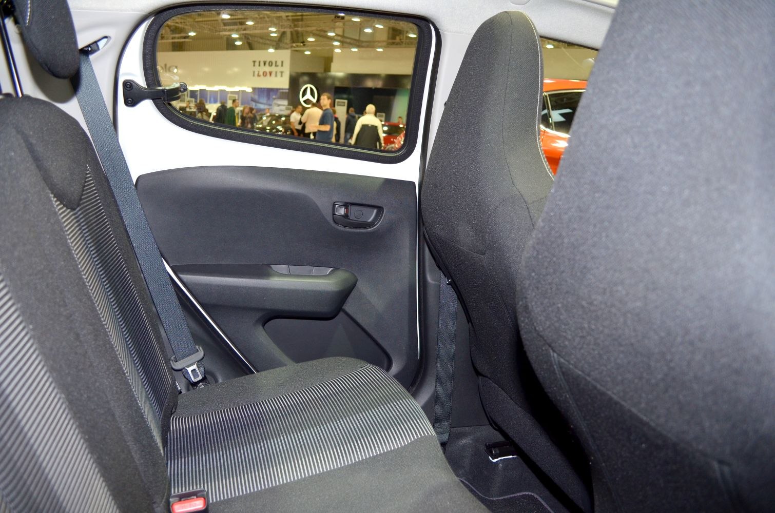Rear passenger seat and door panel with seatbelt and upholstery details