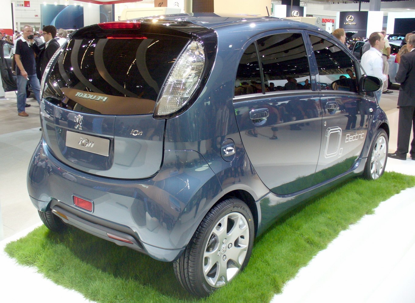 Rear-side view of a five-door electric compact hatchback with distinctive taillights.