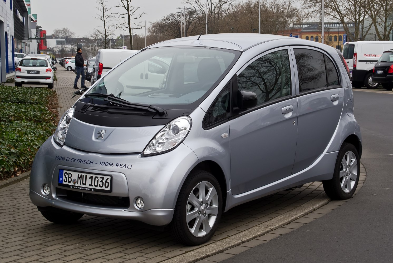 Compact silver electric city car with rounded design