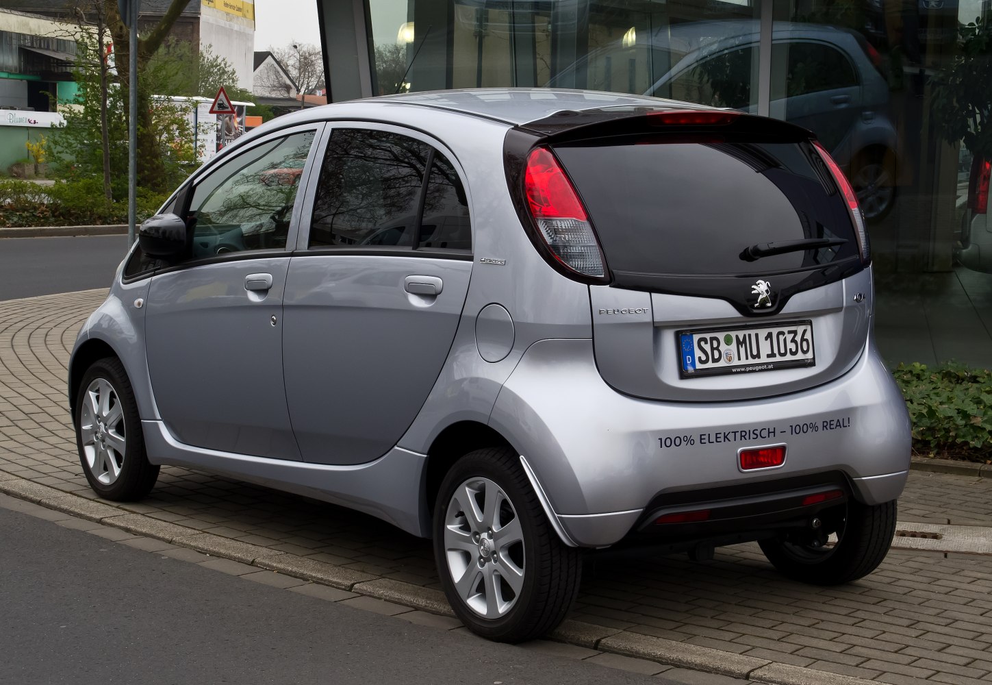 Rear view of compact electric hatchback with distinctive tail lights and tinted rear window