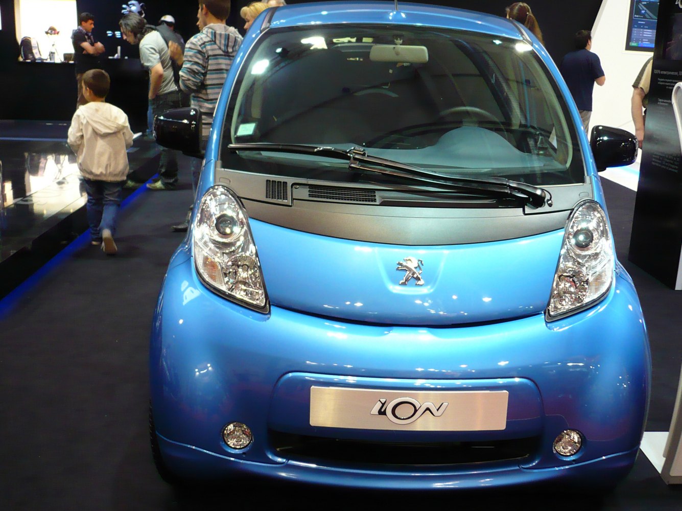 Front view of small electric compact car with distinctive headlights
