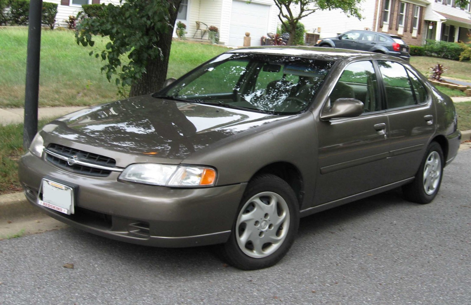 Mid-size sedan front and side view with alloy wheels