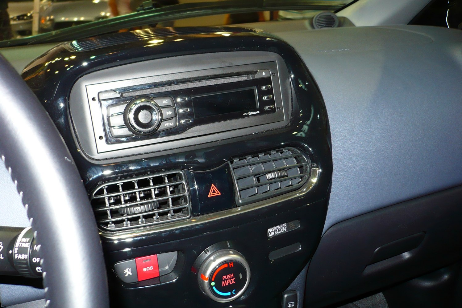 Dashboard center console with air vents, climate control knob, and audio system panel