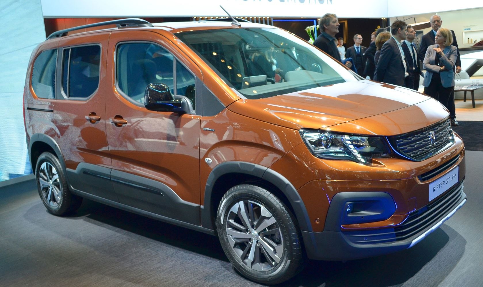 Front-side view and alloy wheel of modern SUV with rugged cladding